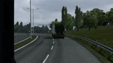 a truck is driving down a highway with the words green logistics visible on the side