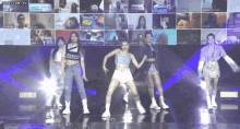 a group of girls are dancing on a stage in front of a screen that says ' honeycam.org '
