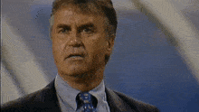 a man in a suit and tie with a very angry look on his face
