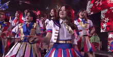 a group of girls are dancing in front of a stage that says drop of a hat on it