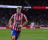 a soccer player wearing a red white and blue jersey with the number 9 on it