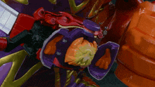 a close up of a toy with a purple and orange object in it