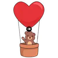 a teddy bear is flying in a hot air balloon with a heart on it