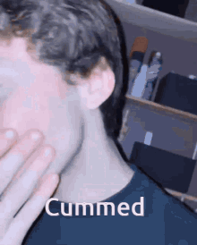 a close up of a person 's face with the word cummed written on it