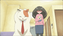 a woman in a pink shirt with a cat on it stands next to a cat in a tie