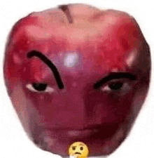 a red apple with a face drawn on it and a smiley face .