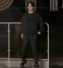 a man wearing a black sweater that says 2lgn4