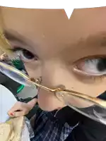 a girl wearing glasses is holding a sandwich