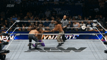 two men are wrestling in a ring with aew written on the bottom