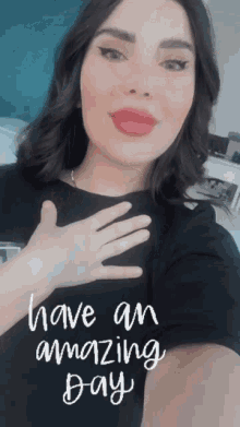 a woman wearing a black shirt with the words have an amazing day written on it