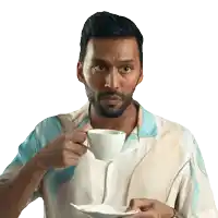 a man with a beard is drinking from a white cup