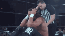 two men in a wrestling ring with the word impact on the ring