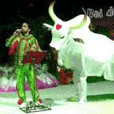 a man singing into a microphone next to a bull with the word boi on the bottom right
