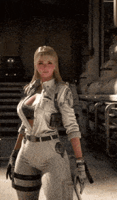 a woman in a white outfit holds a gun in her hand