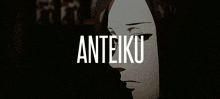 a man in a suit and tie is standing in front of a window with the word anteiku written above him