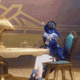 a woman in a blue dress is sitting in a chair