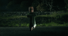 a person is flying through the air on a road at night