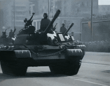 a black and white photo of a row of military tanks