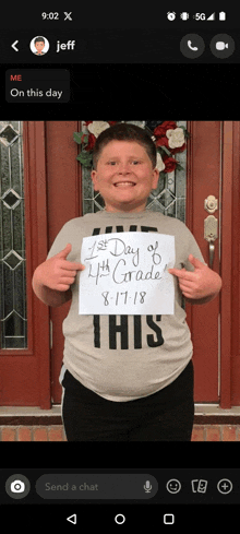 a young boy holding a sign that says 1st day of 4th grade