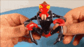 a person is holding a toy that looks like a spider