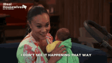 a woman holding a baby with the words " i don t see it happening that way "