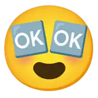 a yellow smiley face with two blue squares that say ok on it