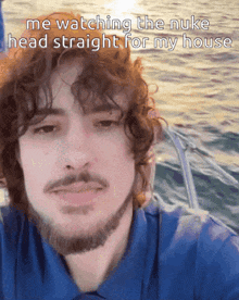 a man with curly hair and a beard is watching the nuke head straight for my house
