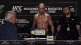 a man is standing in front of a sign that says ufc 315