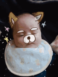 a baby wearing a bib has a drawing of a dog face on his face