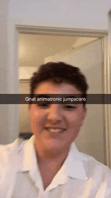 a man in a white shirt is smiling with a caption that says gnat animatronic jumpscare