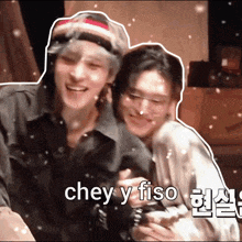 two men are hugging each other with the words chey y fiso written on the bottom of the image