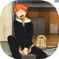a boy with orange hair is sitting on the floor with a backpack