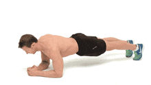 a shirtless man is doing a plank exercise while wearing nike shoes