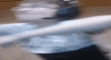 a blurry picture of a person holding a spoon in their hand .