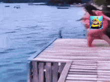 a picture of a frog on a boat is on a wooden dock next to a body of water