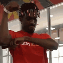 a man wearing a red shirt that says stay