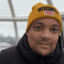 a man wearing a yellow hat that says london