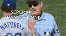a baseball player is shaking hands with a referee while another player looks on .