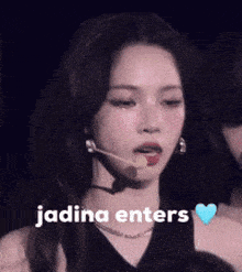 a woman with a microphone in her mouth and the words " jadina enters " next to her