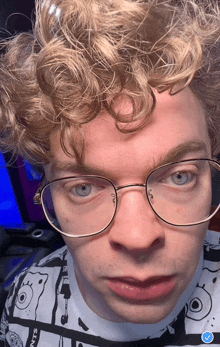 a close up of a person wearing glasses and a shirt that says spongebob on it