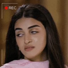a woman 's face is being recorded by a camera with the word rec above it