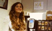 a woman stands in front of a sign that says oops