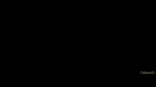 a man is looking out of a window in a dark room .