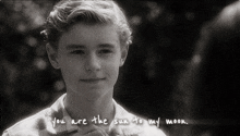 a black and white photo of a young boy with the words " you are the sun to my moon " written on the bottom