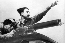 a black and white photo of two men pointing a gun