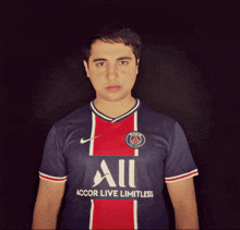 a man wearing a blue and red shirt that says accor live limitless