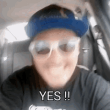 a man wearing a blue hat and sunglasses says yes