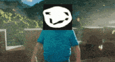 a man in a blue shirt has a white smiley face on his head