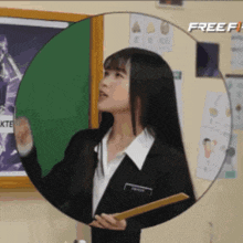 a woman in a suit is holding a ruler in front of a chalkboard with the word free on it
