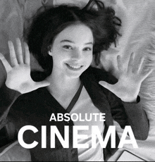 a black and white photo of a woman laying on a bed with the words absolute cinema below her